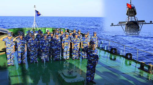 Coast guards salute the flag of Vietnam at Paracel